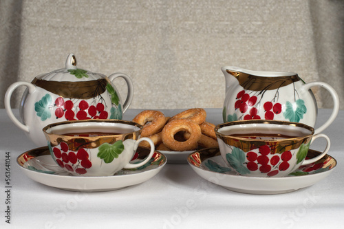 tea set with cookies on a white tablecloth
