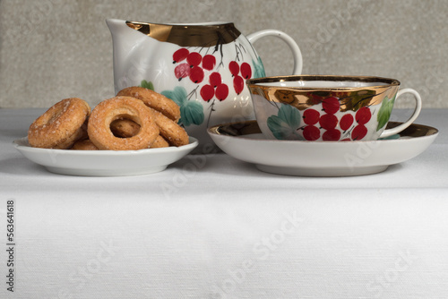 tea set with cookies on a white tablecloth