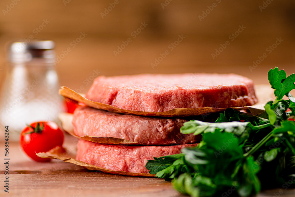 Raw burger with fresh tomatoes. Raw burger with fresh tomatoes.