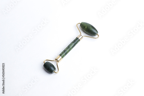Fototapeta Naklejka Na Ścianę i Meble -  Skin care tools. Close-up of a jade facial roller or beauty roller for better blood circulation and muscle activation isolated on white. Beauty concept. 
