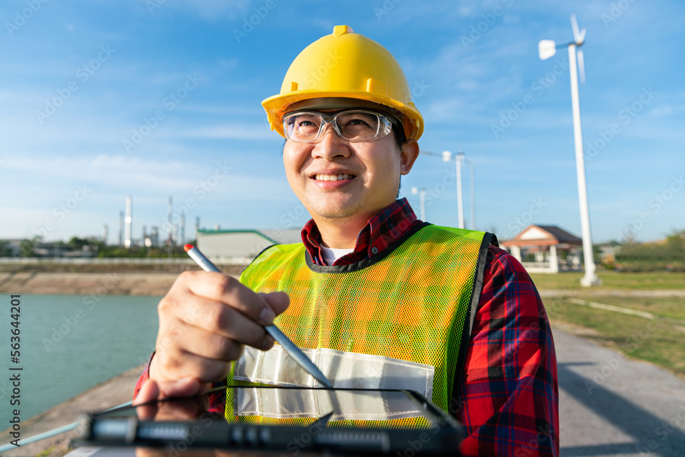 engineer wear safety helmet uniform work with drawing 3D detail in tablet technology with oil refinery, petrochemical, petroleum chemical plastic industrial business in background engineer wear safety helmet uniform work with drawing 3D detail in tablet technology with oil refinery, petrochemical, petroleum chemical plastic industrial business in background