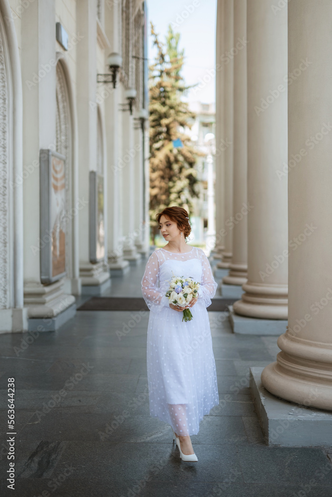 portrait of a young bride girl in a light dress in an urban environment portrait of a young bride girl in a light dress in an urban environment