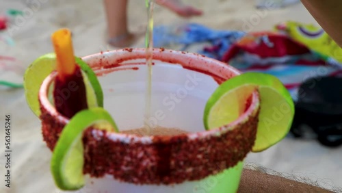 Making mexican style beer clamato with chili lime on beach in Mexico. photo