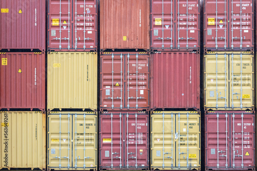 Tablou pe pânză Stack of shipping containers with made-up numbers and without logos, import/expo