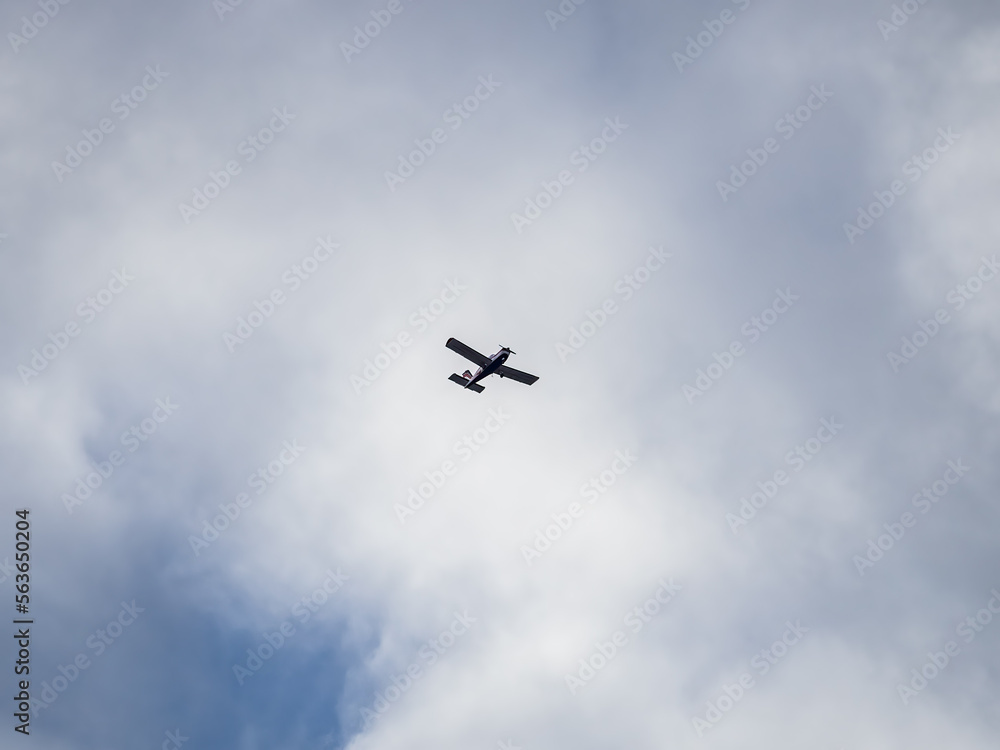 Small ultralight airplane with overhead wing and single propeller flying in sunset sky. Small ultralight airplane with overhead wing and single propeller flying in sunset sky.