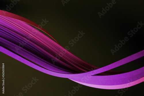 Neon Pink Violet color strip wave curve paper line on black. Abstract texture background.