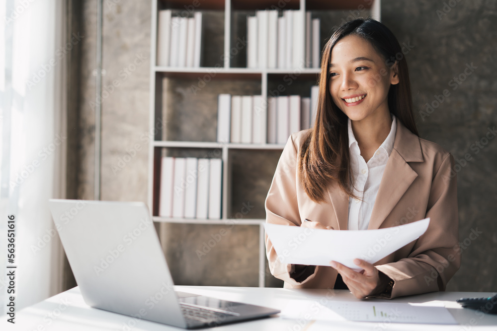 Young Happy Businesswoman Using Computer in Modern Office with Colleagues. Stylish Beautiful Manager Smiling, Working on Financial and Marketing Projects. Young Happy Businesswoman Using Computer in Modern Office with Colleagues. Stylish Beautiful Manager Smiling, Working on Financial and Marketing Projects.