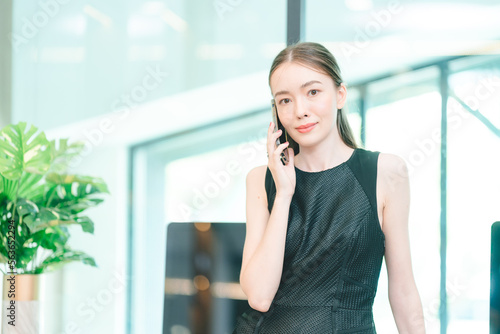 freelance business woman using smartphone or mobile phone to work on online communication technology, young Asian businesswoman or female entrepreneur with laptop computer to working on cyberspace