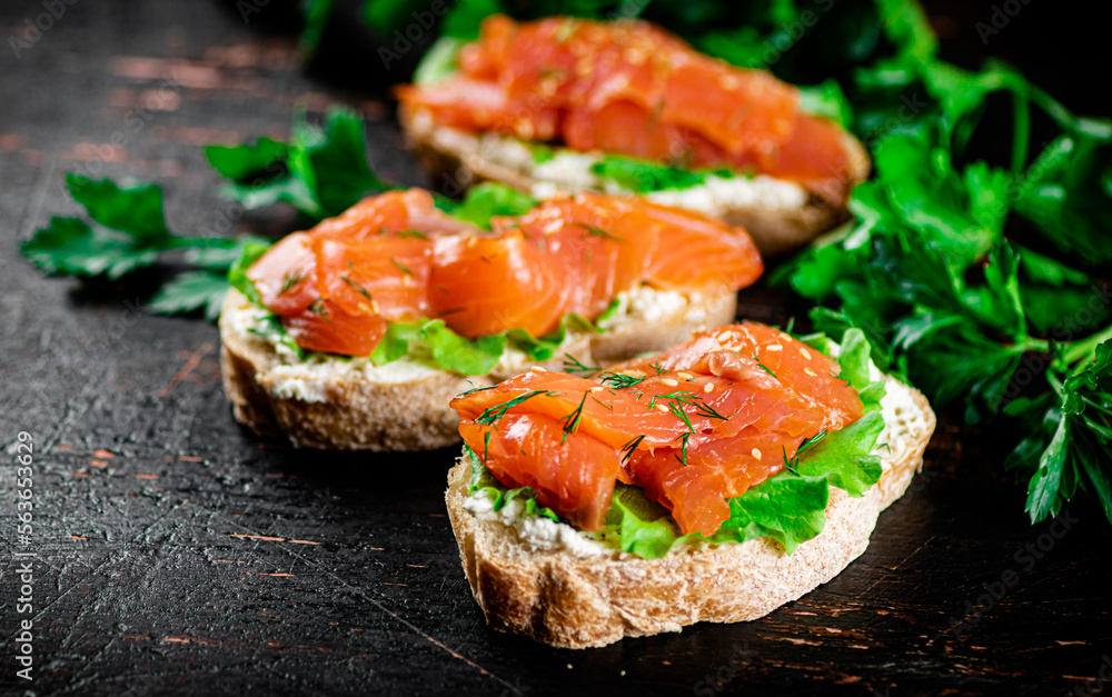 Sandwich with pieces of salmon and greens. Sandwich with pieces of salmon and greens.