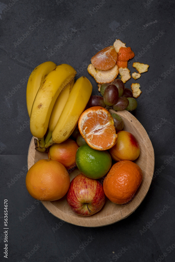 Trough with varied fruits on black background Trough with varied fruits on black background