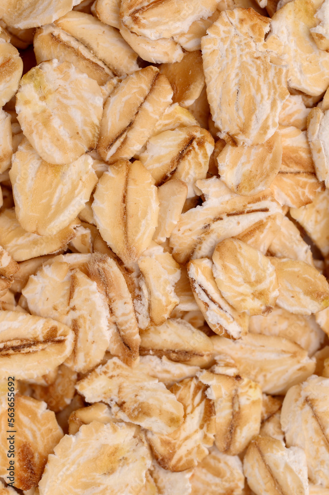 Macro photo of oatmeal.Texture, background of dry oatmeal.Healthy, delicious food, source of amino acids,minerals, vitamins.Top view Macro photo of oatmeal.Texture, background of dry oatmeal.Healthy, delicious food, source of amino acids,minerals, vitamins.Top view