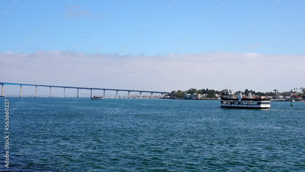 Distant view of Coronado bridge over San Diego bay with clear sky in the background during summer time Distant view of Coronado bridge over San Diego bay with clear sky in the background during summer time