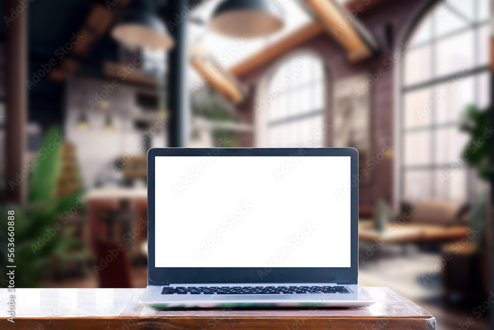 Laptop computer on wood desk at office or co-working space, Laptop with white blank on screen and blurred background , working space concept. Laptop computer on wood desk at office or co-working space, Laptop with white blank on screen and blurred background , working space concept.