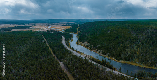 Yellowstone National Park aerial panoramic view. Endless forests and river going through the valley.