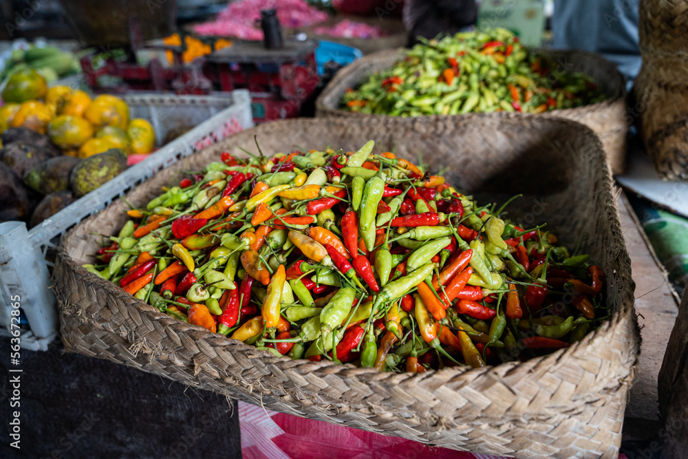 Fototapeta premium A basket full of fresh Indonesian chilli peppers, also called rawit or bird's eye chili