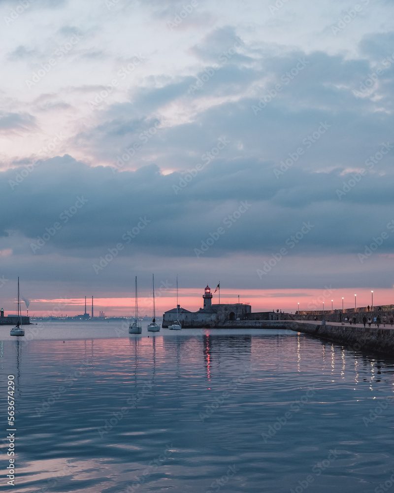 Dun Laoghaire harbour at dusk, lighthouse and few boats, Dublin, Ireland