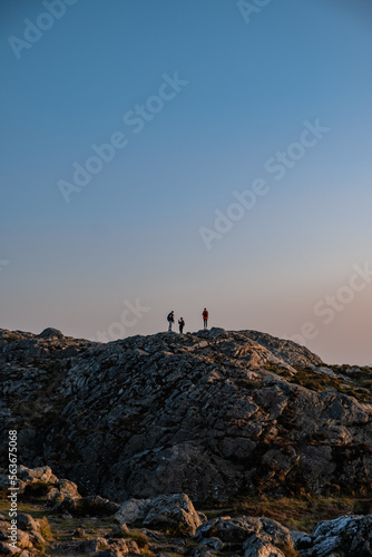 silhouettes of people on top of the mountain at dusk, view from Bray Head, Ireland