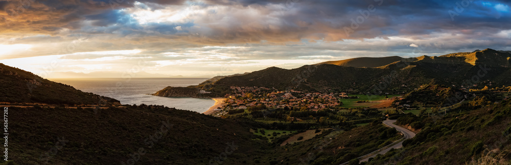 Scenic Highway on the Sea Coast near Small Town, Solanas, Sardinia. Dramatic Sunset Sky. Panorama Scenic Highway on the Sea Coast near Small Town, Solanas, Sardinia. Dramatic Sunset Sky. Panorama