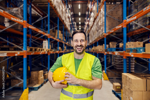 Portrait of a warehouseman smiling at the camera in facility.