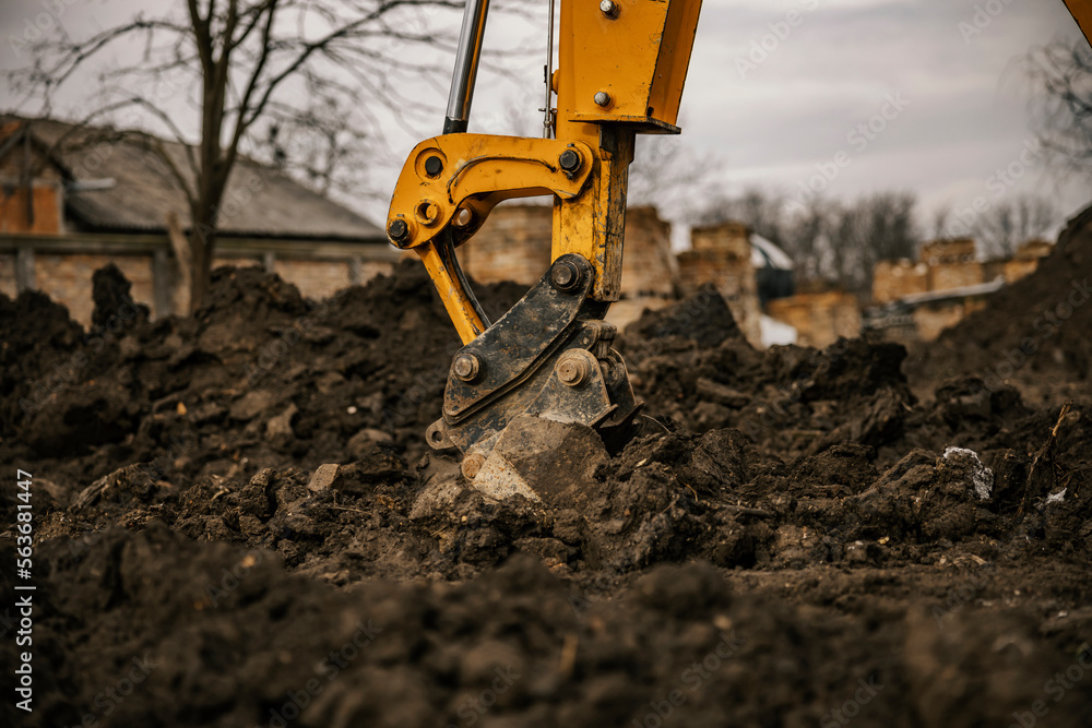 Cropped picture of digger digging earth with bucket. Cropped picture of digger digging earth with bucket.