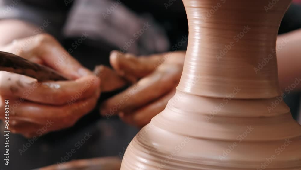 Potter working on potters wheel making ceramic pot from clay in pottery workshop. Traditional art concept, creative workshop and masterclass Potter working on potters wheel making ceramic pot from clay in pottery workshop. Traditional art concept, creative workshop and masterclass