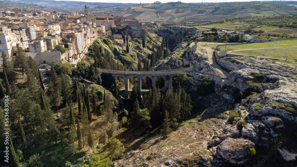 Canyon of Gravina with the old aqueduct stone bridge. Apulia region, Italy