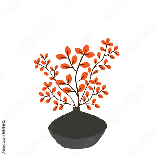 Florero con ramas de hojas anaranjadas.