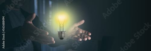 Man hands holding light bulb illuminate. Creativity innovation, new idea, business growth concept.