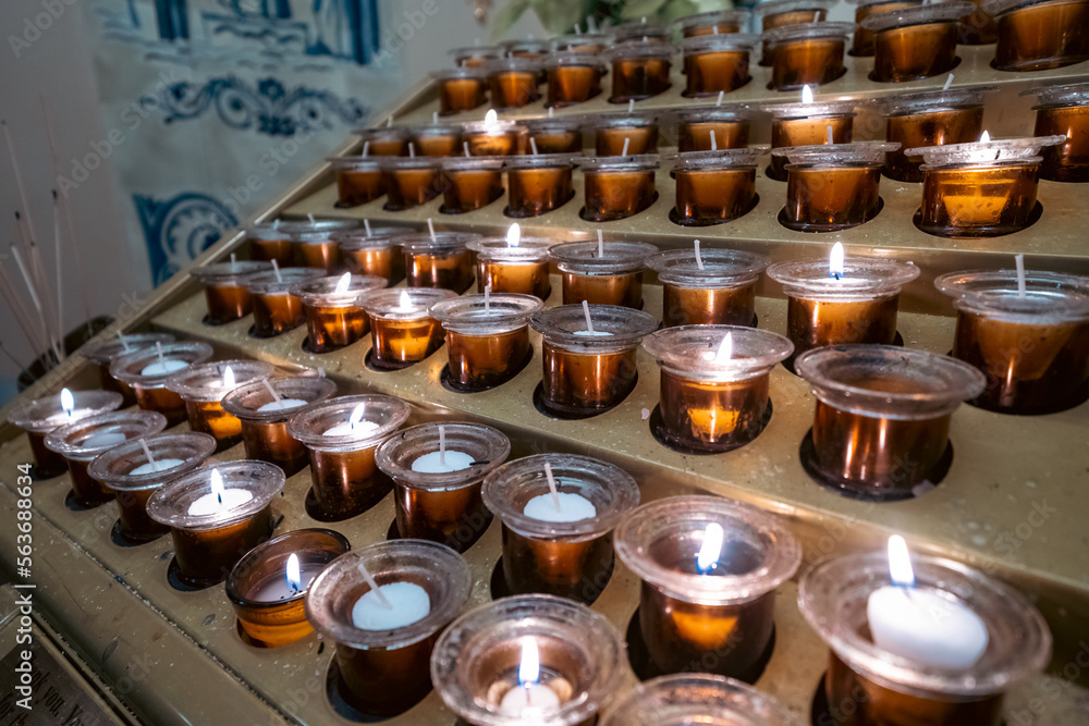 Prayer candles in votives, and insence, inside of a Catholic church Prayer candles in votives, and insence, inside of a Catholic church