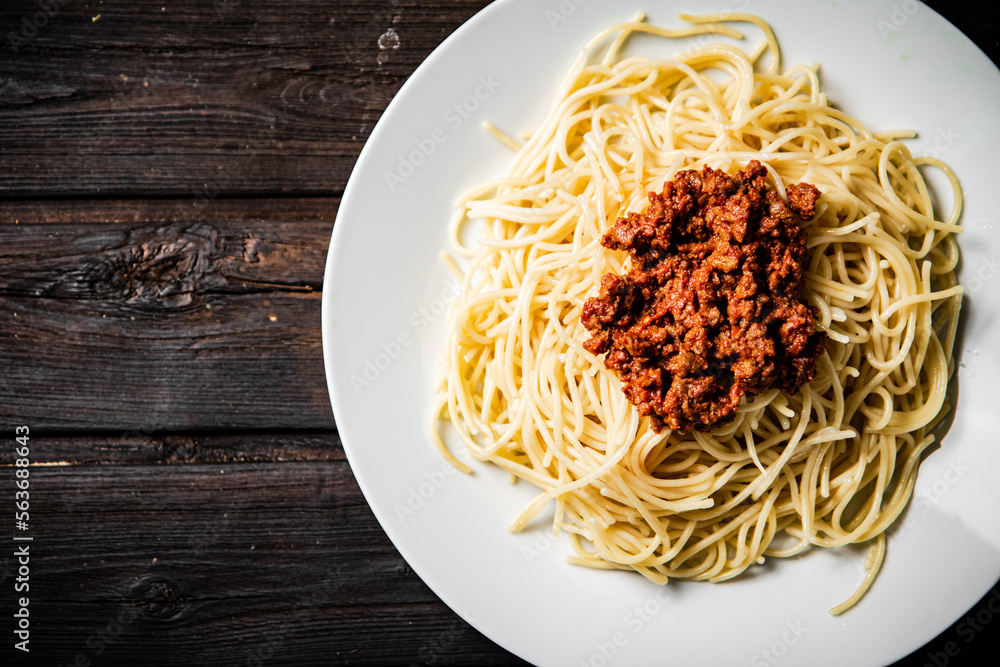 A full plate of spaghetti bolognese on the table. A full plate of spaghetti bolognese on the table.