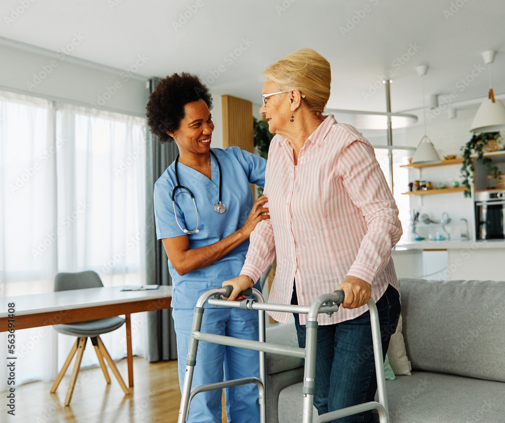 Fototapeta premium nurse doctor senior care caregiver help walker assistence retirement home nursing elderly woman black african american hospital clinic home disability disabled