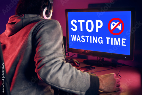 Vászonkép Young man sitting in front of PC screen showing blue screen with warning message Stop wasting time