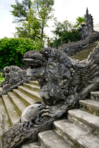 Dragons stone figures as a stairs handrails outside Khai Dinh Mausoleum in Hue, Vietnam 