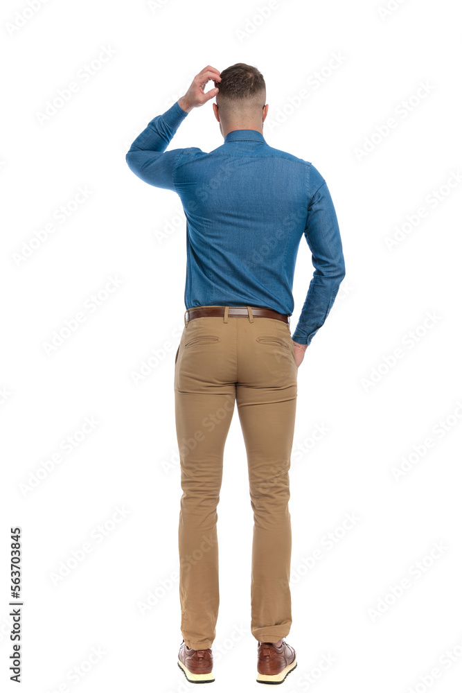 confused young guy in denim shirt scratching head and thinking confused young guy in denim shirt scratching head and thinking
