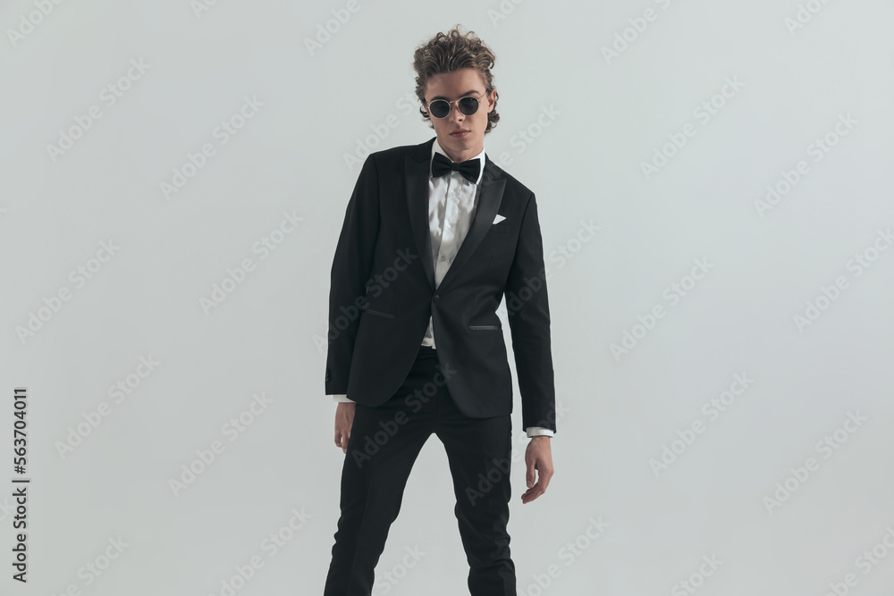 sexy caucasian man with curly hair wearing elegant tuxedo and posing sexy caucasian man with curly hair wearing elegant tuxedo and posing