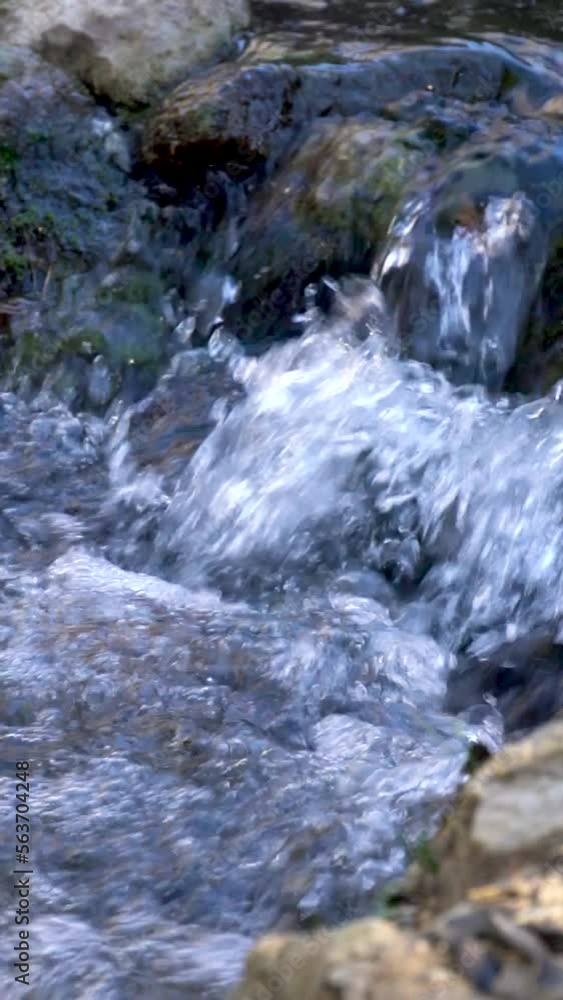 Slow motion. Flowing water in the rocks of a river Slow motion. Flowing water in the rocks of a river