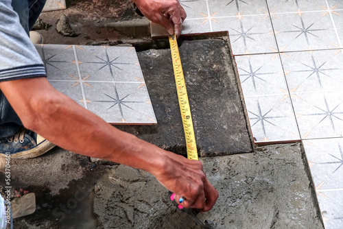 Installation of ceramic floor tiles, Workers are measuring to install floor tiles, install floor tiles. 