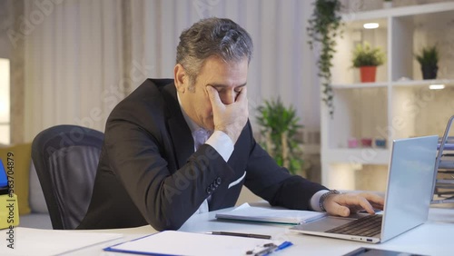 Tired mature businessman with sleepiness falling asleep in his home office.
Tired mature businessman feeling sluggish and falling asleep at the table.
