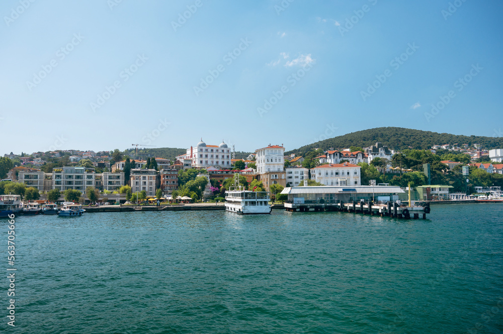 Panoramic sea view of the resort town with houses in the mountains and a pier  with boats on a Adalar