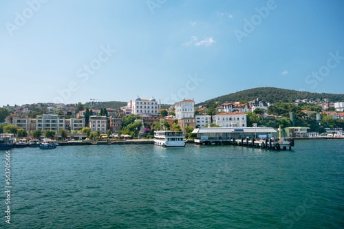 Panoramic sea view of the resort town with houses in the mountains and a pier  with boats on a Adalar