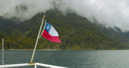 Bandera chilena en un bote recorriendo el Lago Todos los Santos, en el sur de Chile photo