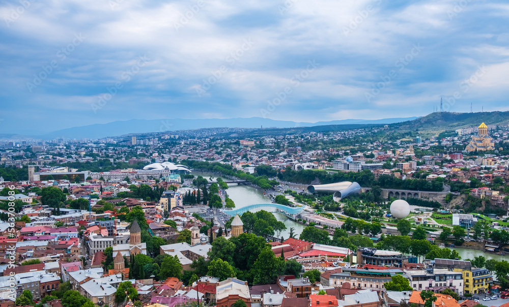 Old Tbilisi cityscape with Mtkvari or Kura river, Cathedral, bridge of peace, Rike park and presidential palace. Tiflis is popular tourist destination in Georgia