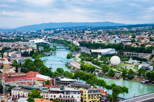 Old Tbilisi from above with Mtkvari or Kura river, bridge of peace, Rike park, hot air balloon, cable car and presidential palace. Tiflis is popular tourist destination in Georgia photo