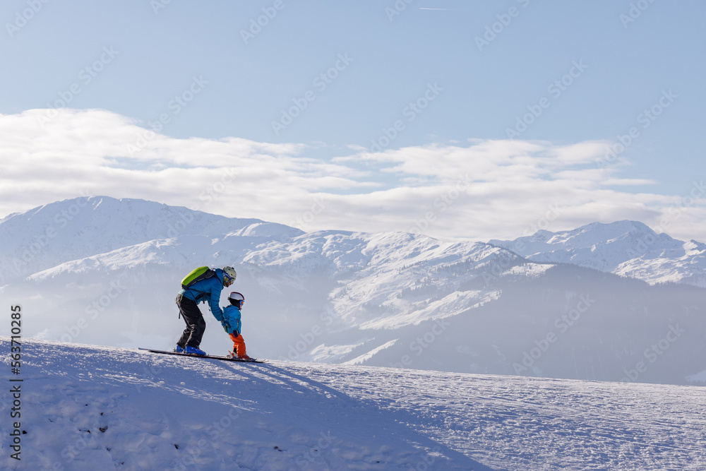 children skiing and snowboarding in the mountains, ski resort