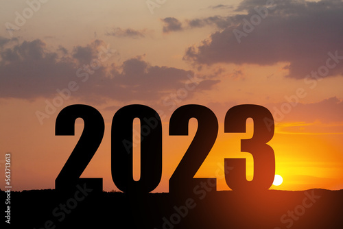 Silhouette 2023 with sunset sky at mountain and number like 2023 abstract background. Concept of start with strategy, win, plan, goal and objective target.