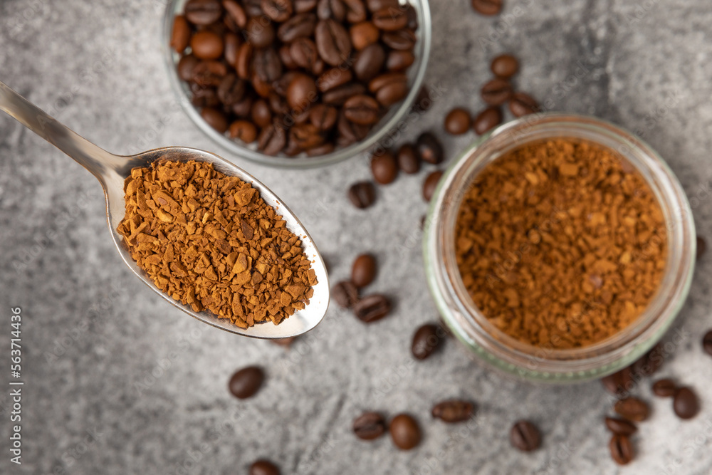 Instant coffee and coffee beans on a black stone background. Aromatic coffee drink. Place for text. Space for copy text Instant coffee and coffee beans on a black stone background. Aromatic coffee drink. Place for text. Space for copy text