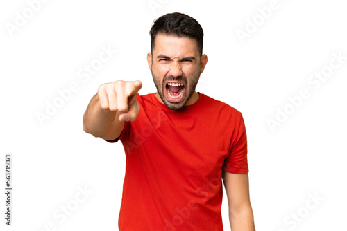 Young handsome caucasian man over isolated chroma key background frustrated and pointing to the front