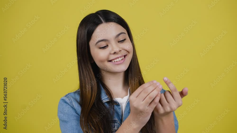 Closeup of a beautiful teen girl enumerating her plans, dreamily looking aside and smiling at camera