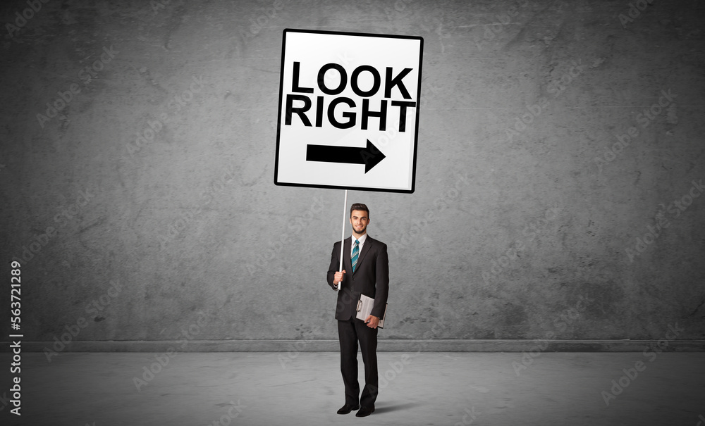 business person holding a traffic sign business person holding a traffic sign