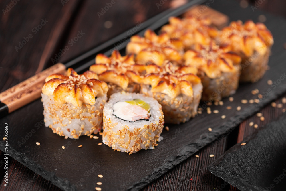 Sushi roll philadelphia with crab avocado and cream cheese on black background close-up. Sushi menu. Japanese food concept Sushi roll philadelphia with crab avocado and cream cheese on black background close-up. Sushi menu. Japanese food concept